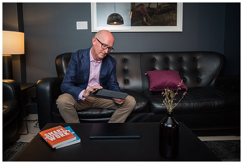 Personal Brand Portrait Shoot with man sitting on couch working